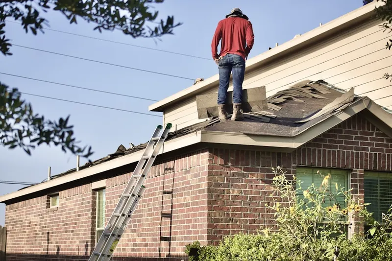 Professional roofer working on a residential roof in Brumbaugh